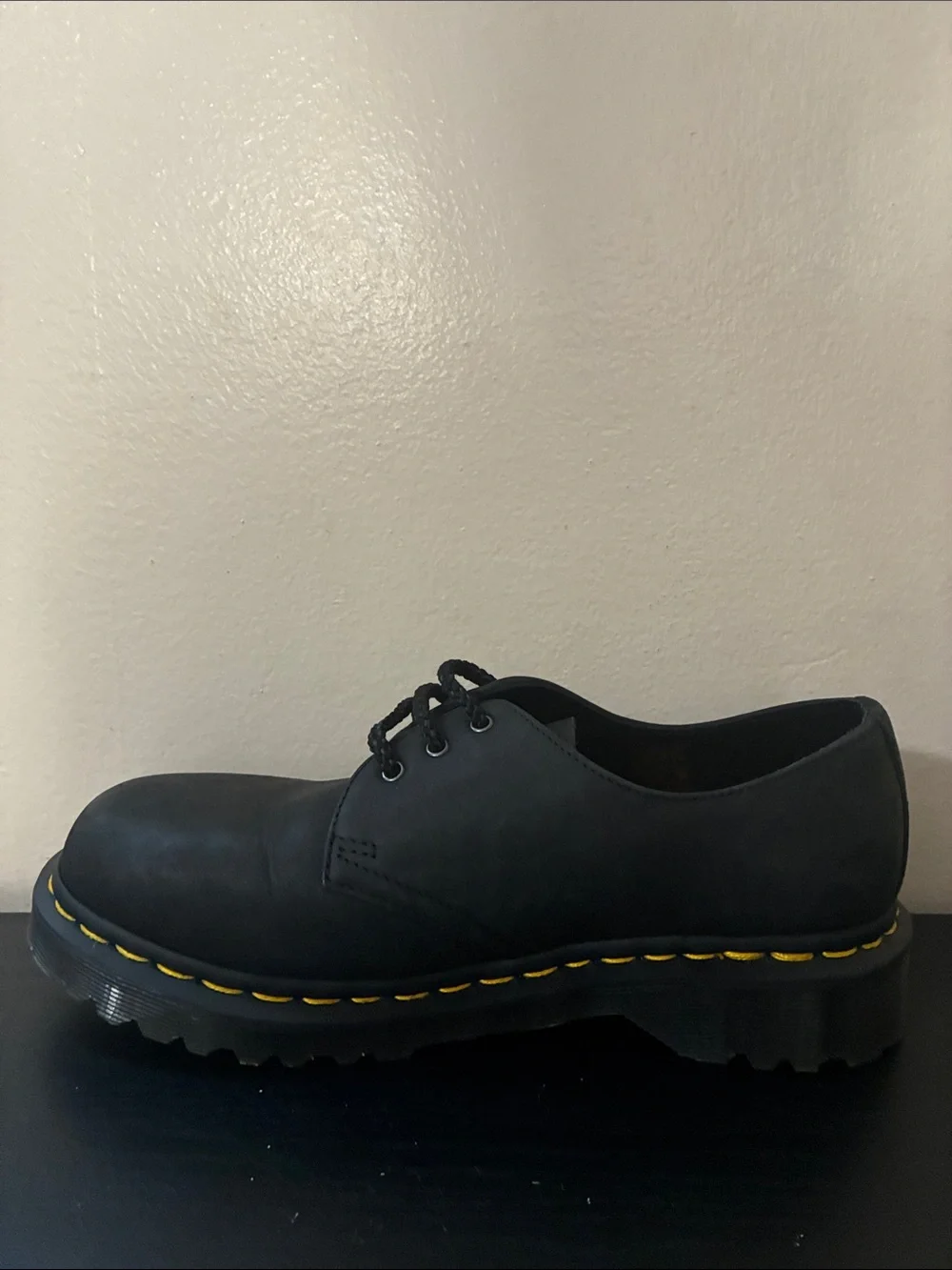 Dr. Martens 1461 leather oxfords feature the brand's signature yellow size 8